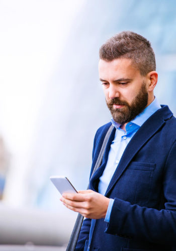 hipster-manager-with-smart-phone-london-city-hall-PBBAF8T